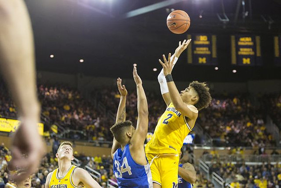 Jon Teske (15) and Jordan Poole (2)