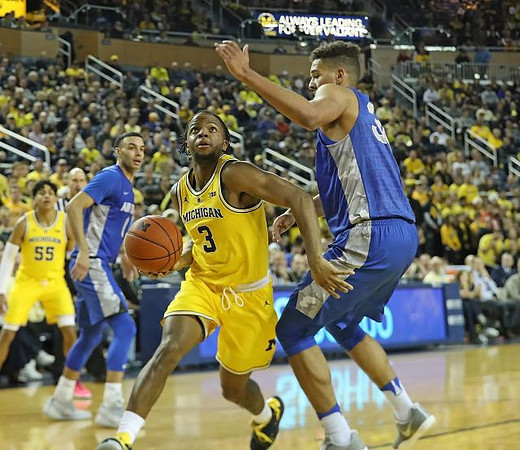 Eli Brooks (55) and Zavier Simpson (3)