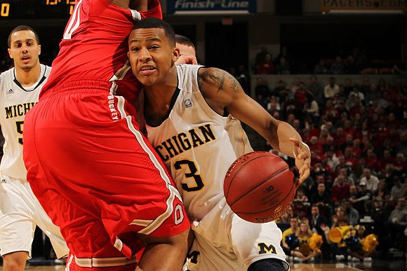 Jordan Morgan (52) and Trey Burke (3)