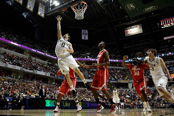 Zack Novak (0), Trey Burke (3), and Evan Smotrycz (23)