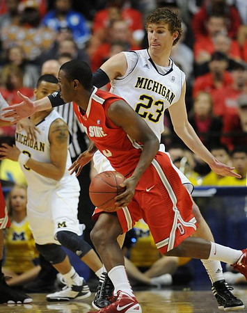 Trey Burke (3) and Evan Smotrycz (23)