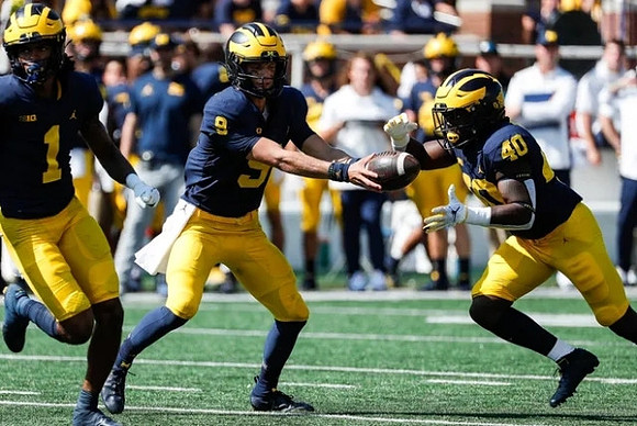 Andrel Anthony (1), J.J. McCarthy (9), and Leon Franklin (40)