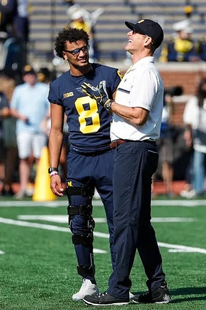 Ronnie Bell (8), and Jim Harbaugh