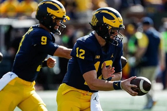 J.J. McCarthy (9), and Cade McNamara (12)