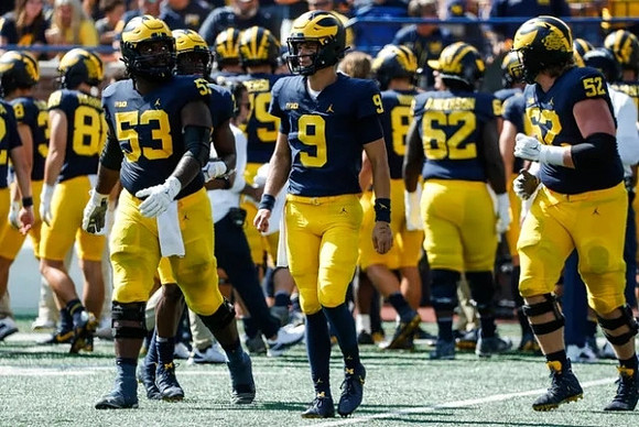 Trente Jones (53), J.J. McCarthy (9), and Karsen Barnhart (52)
