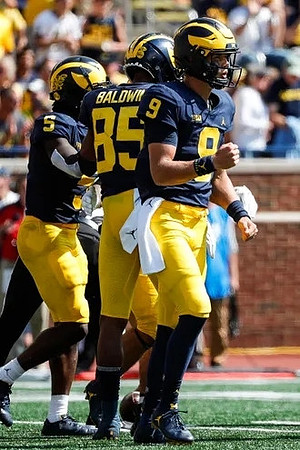 Mike Sainristil (5), Daylen Baldwin (85), and J.J. McCarthy (9)