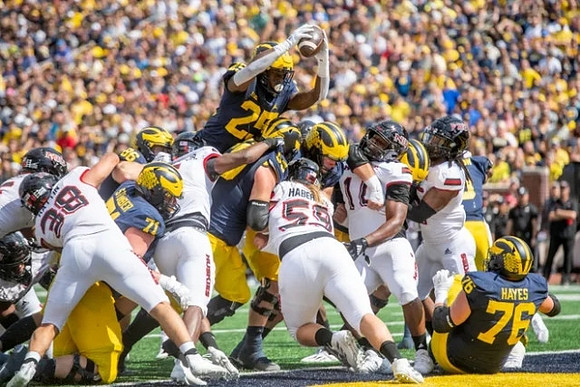 Andrew Stueber (71), Luke Schoonmaker (86), and Hassan Haskins (25)