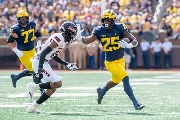 Trevor Keegan (77), and Hassan Haskins (25)