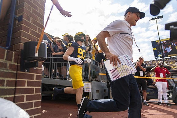 Aidan Hutchinson (97), and Jim Harbaugh