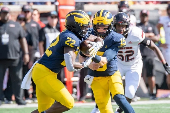 Tavierre Dunlap (22), and Alan Bowman (15)