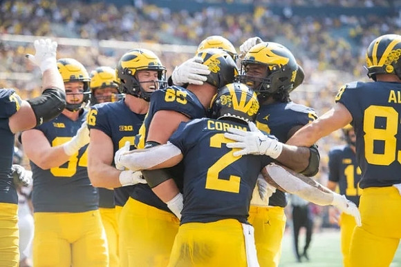 Blake Corum (2), and Michigan Team