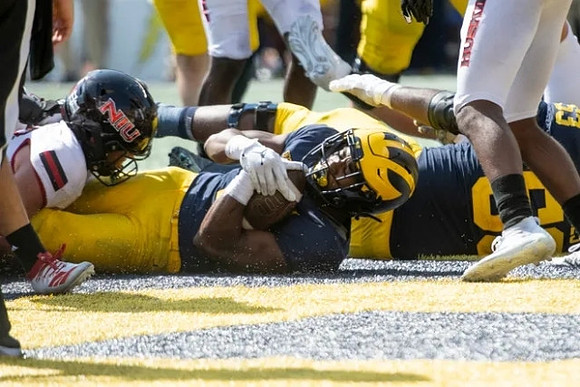 Blake Corum (2), and Trente Jones (53)