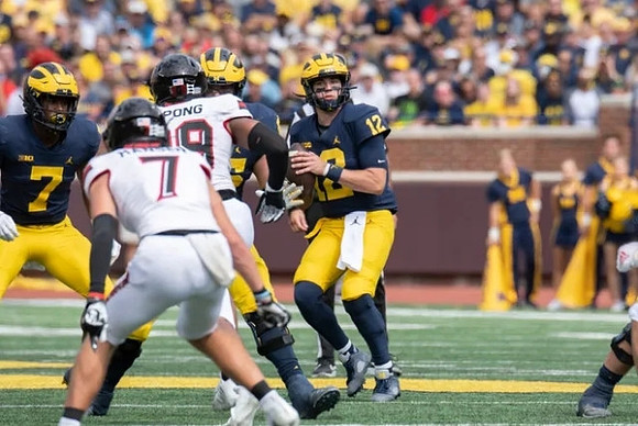 Donovan Edwards (7), and Cade McNamara (12)