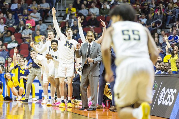 Eli Brooks (55) and Michigan Team