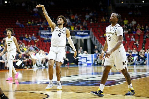 Jordan Poole (2), Isaiah Livers (4), and Zavier Simpson (3)