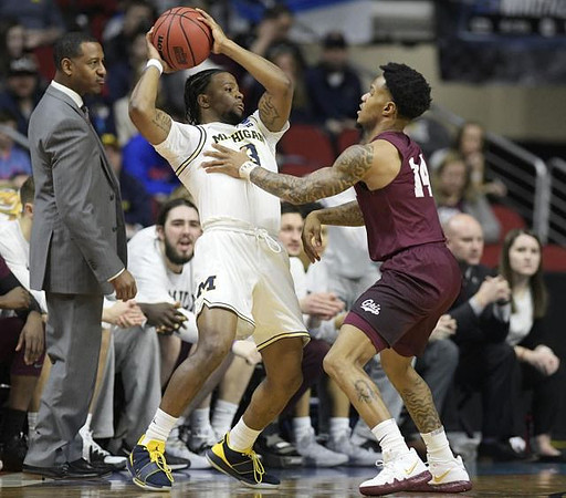 Zavier Simpson (3) and Montana Head Coach Travis DeCuire