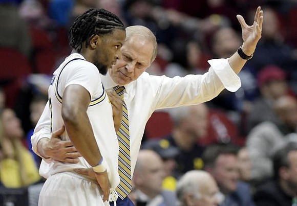 Zavier Simpson (3) and John Beilein