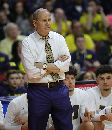 John Beilein, Brandon Johns Jr. (23), and Adrien Nunez (5)