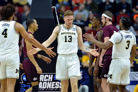 Isaiah Livers (4), Ignas Brazdeikis (13), and Zavier Simpson (3)
