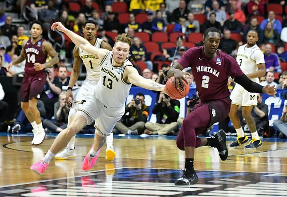 Charles Matthews (1), Ignas Brazdeikis (13), and Zavier Simpson (3)
