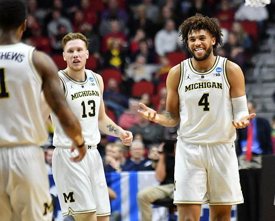 Charles Matthews (1), Ignas Brazdeikis (13), and Isaiah Livers (4)