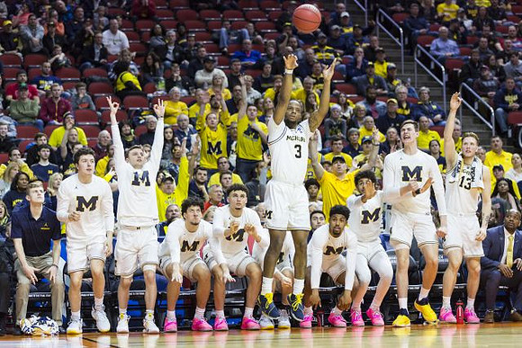 Zavier Simpson (3) and Michigan Team