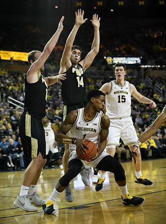 Charles Matthews (1), Jon Teske (15), and Zavier Simpson (3)