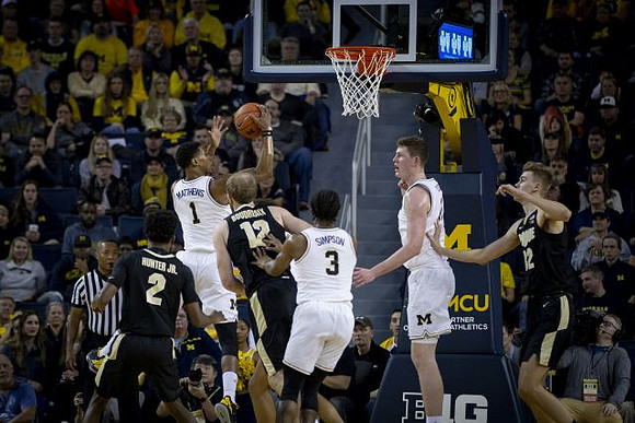 Charles Matthews (1), Zavier Simpson (3), and Jon Teske (15)