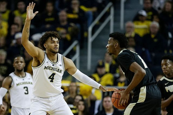 Zavier Simpson (3) and Isaiah Livers (4)