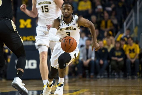 Jon Teske (15) and Zavier Simpson (3)