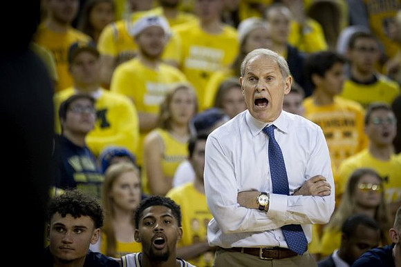 Adrien Nunez (5), David DeJulius (0), and John Beilein