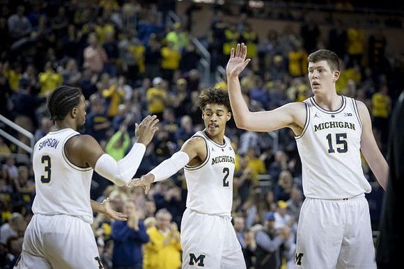 Zavier Simpson (3), Jordan Poole (2), and Jon Teske (15)