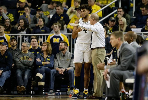 Isaiah Livers (4) and John Beilein