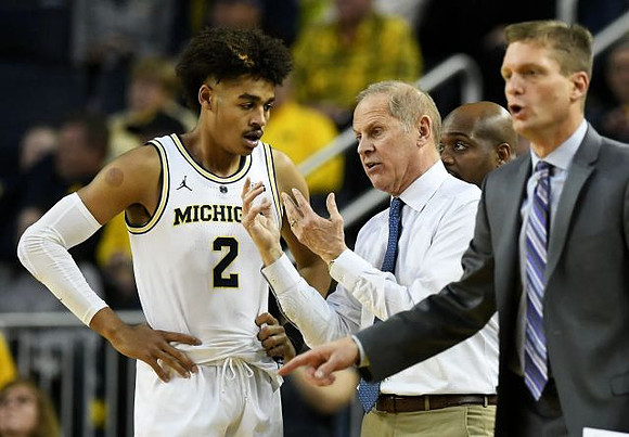 Jordan Poole (2), John Beilein, Deandre Haynes, and Luke Yaklich