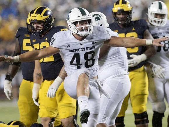 Michael Onwenu (50) and Mason Cole (52)