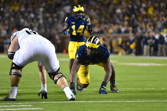 Rashan Gary (3) and Josh Metellus (14)