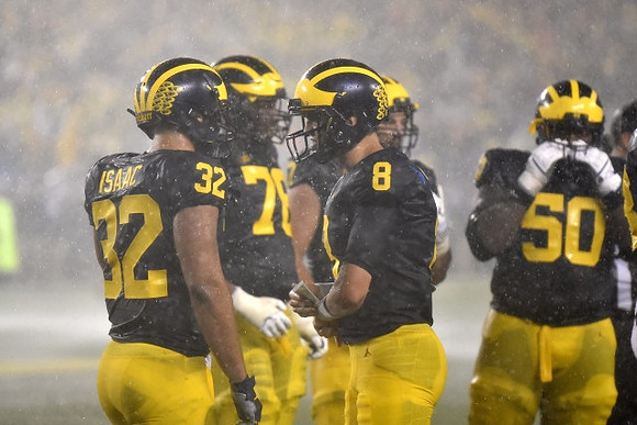 Ty Isaac (32), Juwann Bushell-Beatty (76), John O'Korn (8), and Michael Onwenu (50)