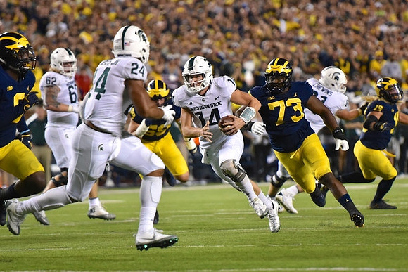 Mike McCray (9), Noah Furbush (59), Maurice Hurst (73), and Chase Winovich (15)