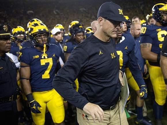 Khaleke Hudson (7) and Jim Harbaugh