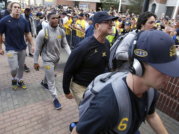 Noah Furbush (59), Josh Ross (12), and Jim Harbaugh