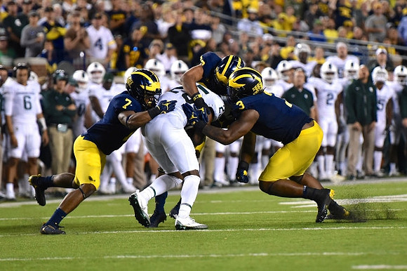 Khaleke Hudson (7), Tyree Kinnel (23), and Rashan Gary (3)