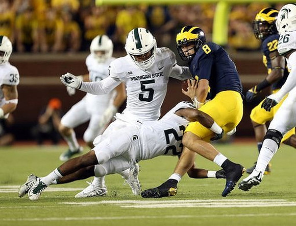 John O'Korn (8) and Karan Higdon (22)