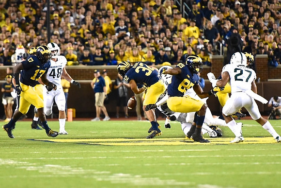 Tyrone Wheatley Jr. (17), Ty Isaac (32), and Maurice Ways (85)