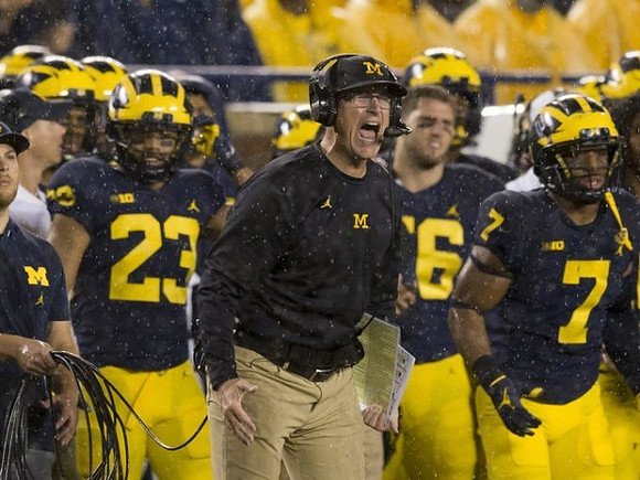 Tyree Kinnel (23), Jim Harbaugh, and Khaleke Hudson (7)