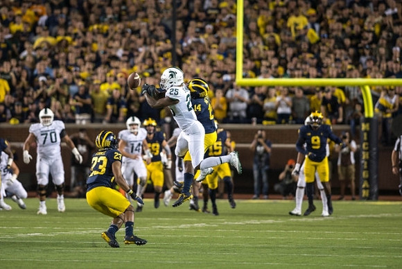 Tyree Kinnel (23), Noah Furbush (59), Josh Metellus (14), Chase Winovich (15), and Mike McCray (9)