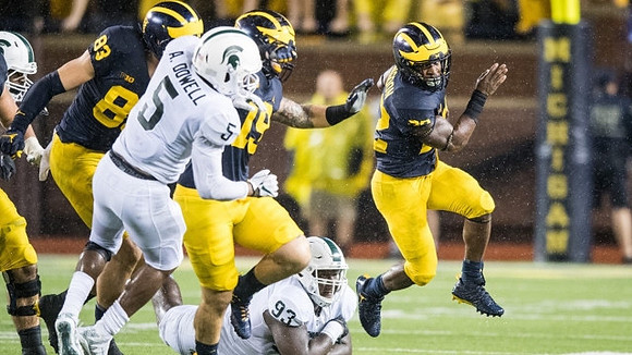 Zach Gentry (83), Henry Poggi (19), and Karan Higdon (22)