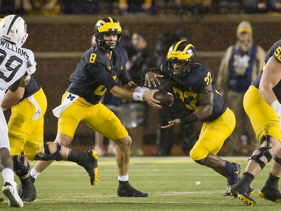 John O'Korn (8), Karan Higdon (22), and Mason Cole (52)