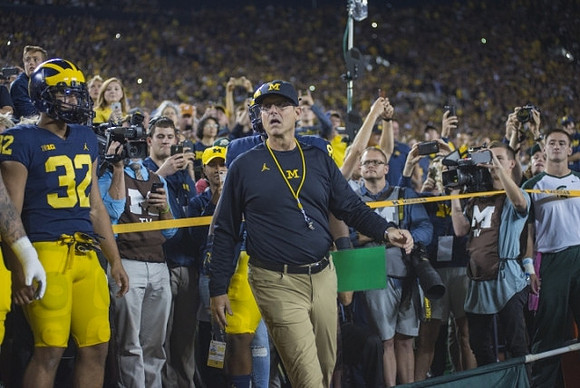 Ty Isaac (32) and Jim Harbaugh