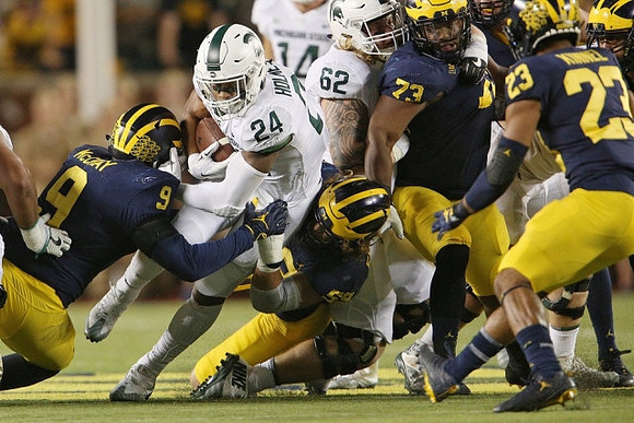 Mike McCray (9), Noah Furbush (59), Maurice Hurst (73), and Tyree Kinnel (23)