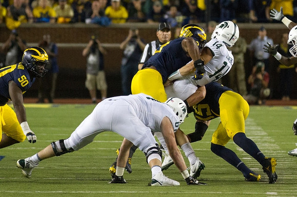 Michael Dwumfour (50), Rashan Gary (3), and Chase Winovich (15)